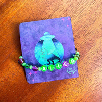 Pulsera postal "Dino alien"